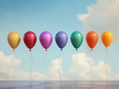 Row of different colored balloons floating in air